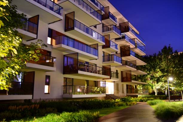 istock Exterior of apartment building at night 1162079271