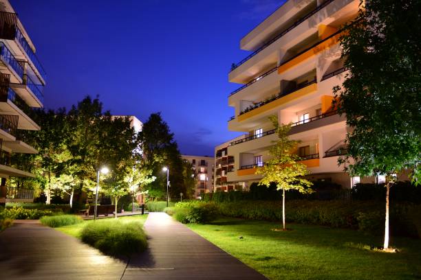 istock Exterior of apartment building at night 1162079400