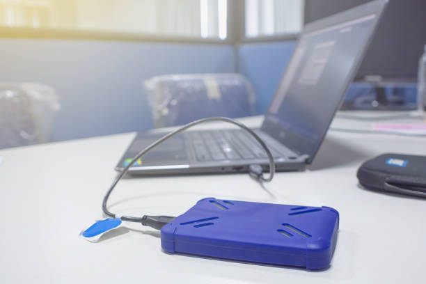 istock portable hard drive connected to a laptop 1162080191