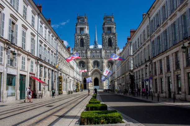 Cathedral Rises above Rue Jeanne d'Arc Orleans, France - August 17, 2018: Sainte-Croix Cathedral rises up above Rue Jeanne d'Arc orleans france photos stock pictures, royalty-free photos & images
