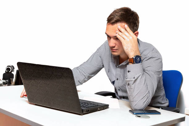istock Worry businessman using laptop while sitting in office. pensive office worker with headache 1162081596