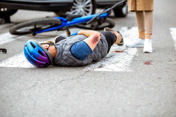 istock Road accident with injured cyclist and car 1162083800