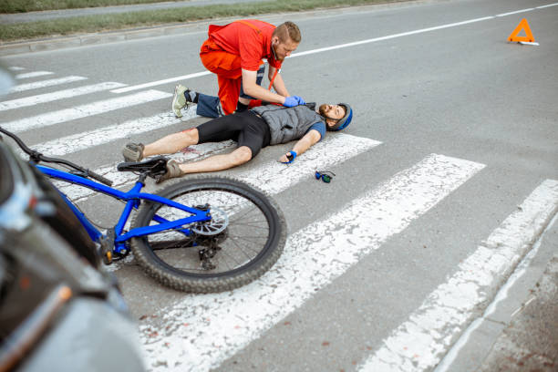 istock Medic applying first aid to the injured man on the road 1162084021
