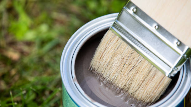 istock Open can of brown paint with brush 1162084920