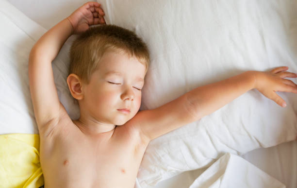 istock Cute little boy lying in bed. 1162086158