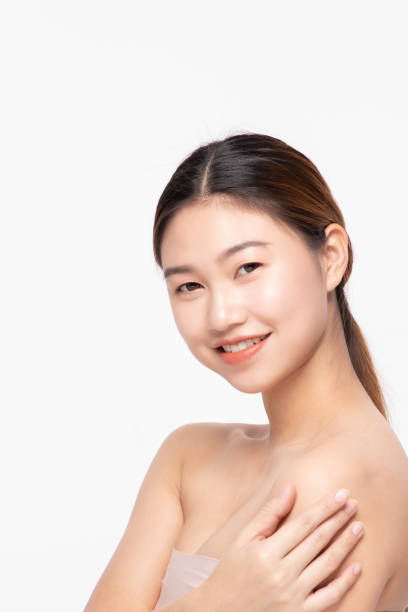 istock Side View Of Beautiful Young Asian Woman Looking While Touching Shoulder feeling so happy and cheerful with healthy Clean and Fresh skin,isolated on white background,Beauty Cosmetology Concept 1162090617