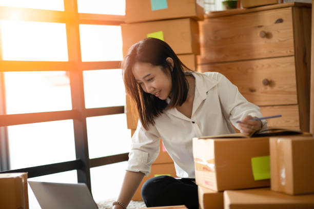 istock women working with laptop and writing requirement and order 1162090910