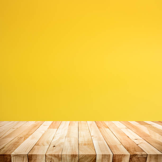 istock Empty of wood table top on yellow pastel color background 1162090927