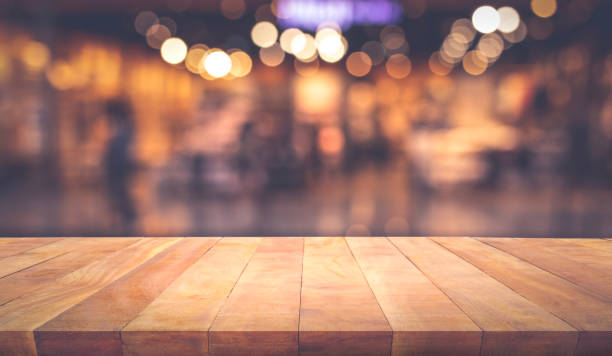 istock Wood texture table top (counter bar) with blur light gold bokeh in cafe,restaurant background 1162090949