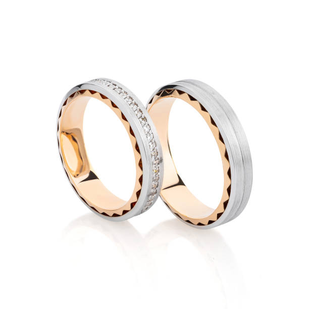 istock Silver and gold wedding rings band with mate surface and gemstones isolated on white 1162092915