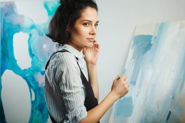 istock Concentrated woman focused on creative art-making process in art therapy 1162093506