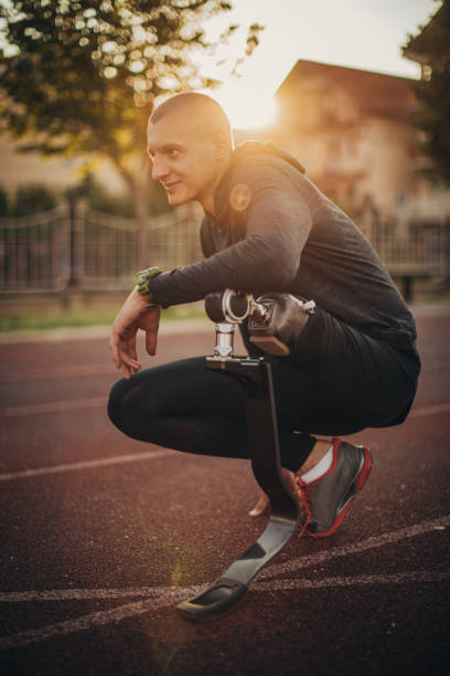 istock Athlete with one leg crouching on race track 1162094622