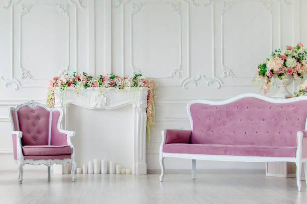 Armchair and sofa. Beautiful interior, decorated with flowers.