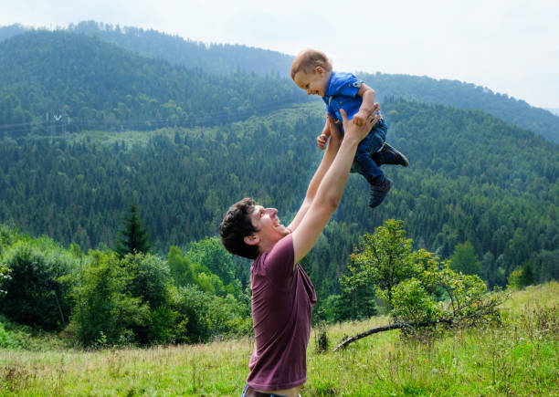 istock Happy young father and little son playing and having fun outdoors. Green mountains on background. Lifestyle. 1162098647