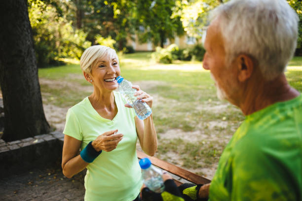 istock Senior couple staying hydrated after running, jogging 1162101814