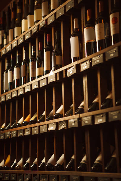 istock Wine cellar with elite drinks on shelves with written names 1162102681