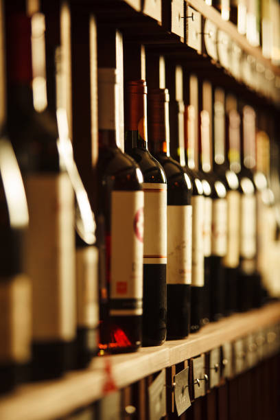 istock Wine cellar with elite drinks on shelves with written names 1162102702