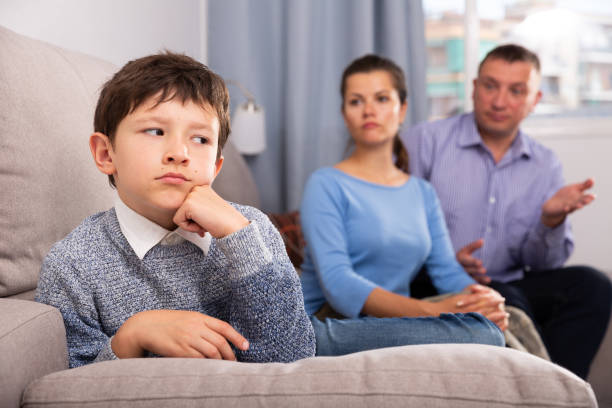 istock Frowning boy with mother and father berating him 1162102915