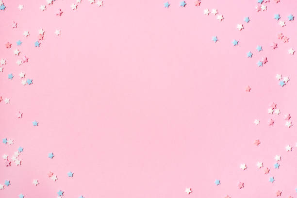 istock Little stars confetti on pink background 1162102939