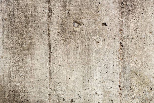 istock Texture of a concrete wall with cracks and scratches which can be used as a background 1162103094