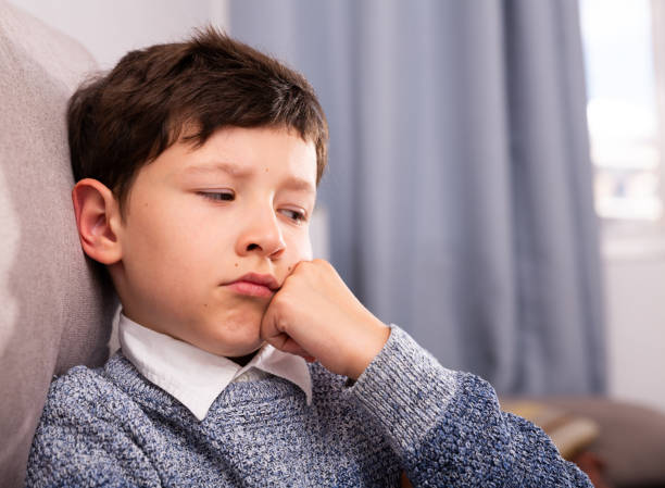 istock Upset  boy sitting  at home 1162103201