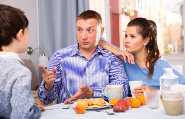 istock Troubled parents reprimanding son 1162103307