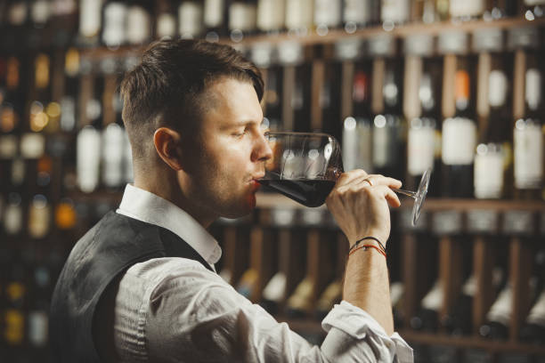 istock Male sommelier tasting red wine at cellar. 1162105371