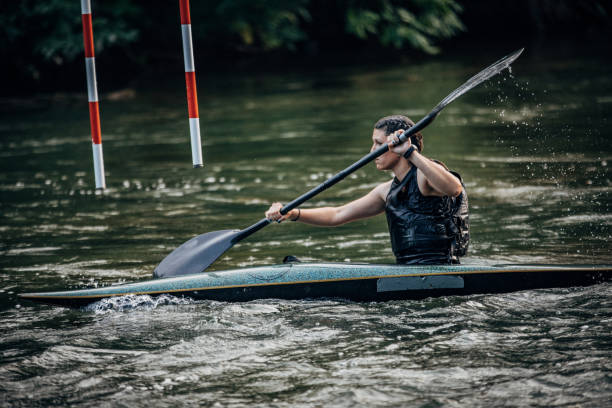 istock Lady kayaker paddling in swift river alone 1162105459