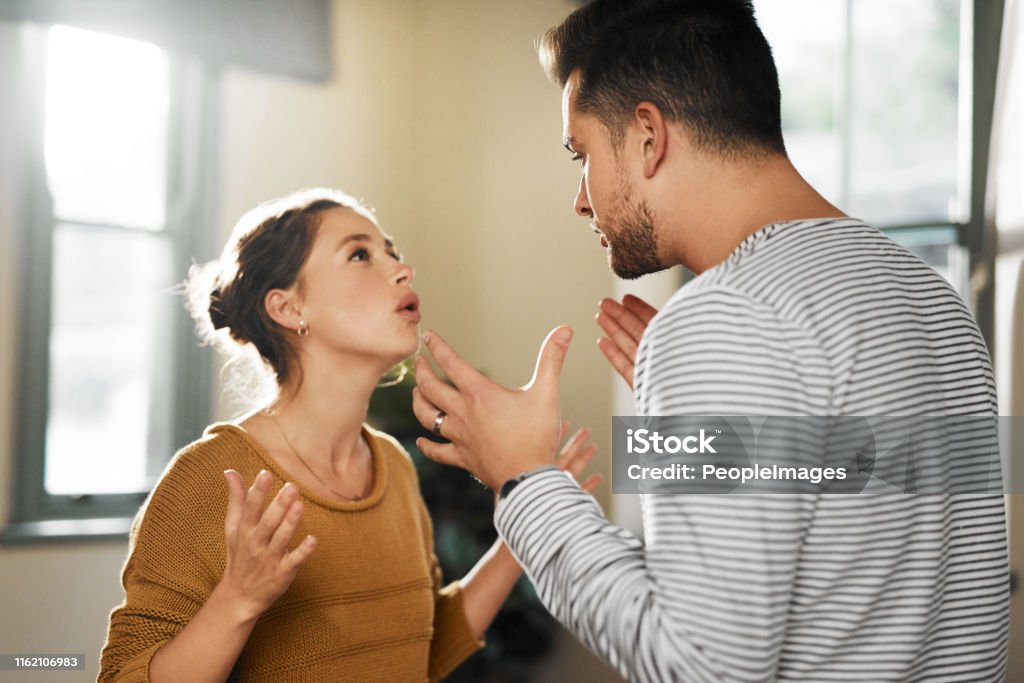 You never listen! Cropped shot of a young couple having an argument at home Couple - Relationship Stock Photo