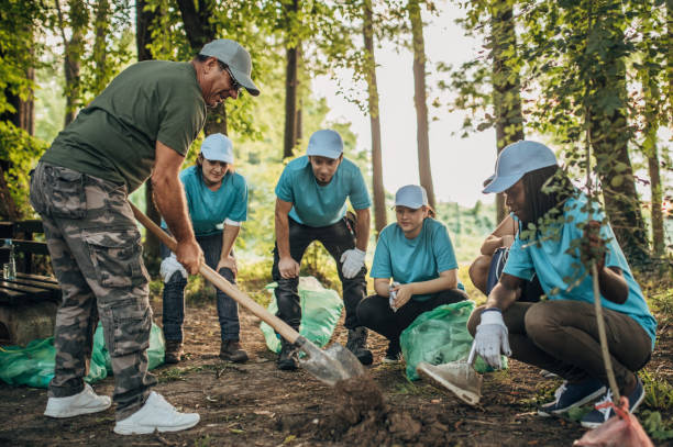 istock Volunteers planting a tree in park 1162107530