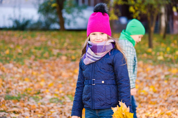 istock Kids walk at autumn park with leaves 1162108589