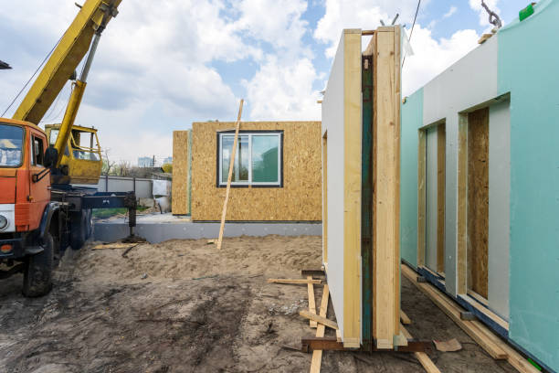 istock Process of construction new and modern modular house from composite sip panels. Energy efficient panel standing near new building and crane 1162109029