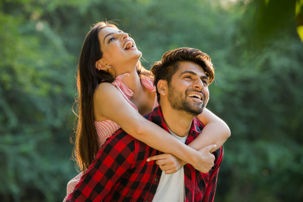 Young couple in public park - stock photo India, 20-29 Years, Adult, Adults Only, Beard  happy couple stock pictures, royalty-free photos & images