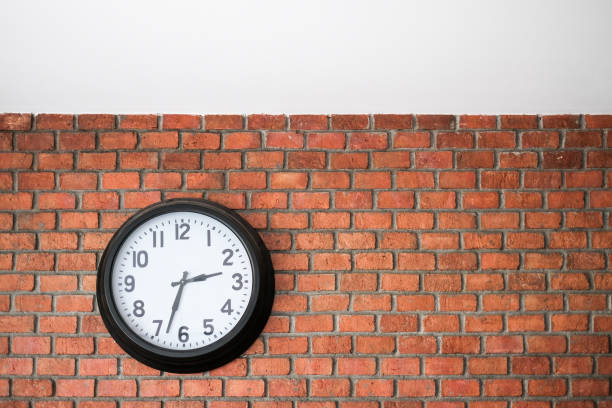 istock Vintage clocks and large number ofold mechanical on old red brick wall 1162110045