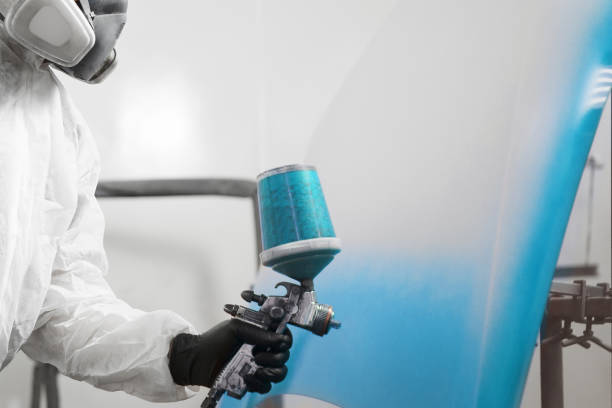 istock Man sprays blue dye on the elements of the vehicle. 1162110199