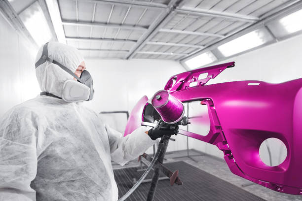 istock Spraying the paint to the car element. Paint coating business. 1162110461