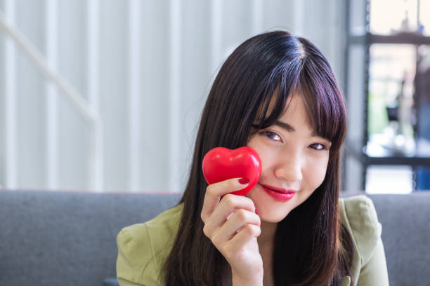 istock Beautiful working woman holding red heart 1162111534