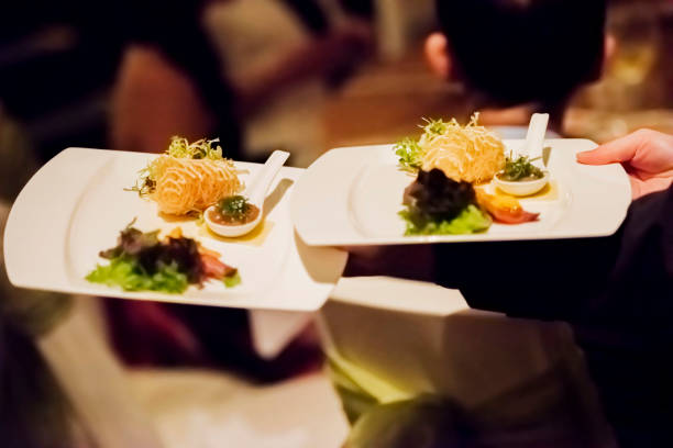 istock Waiter serving two plates with food to the table 1162111737