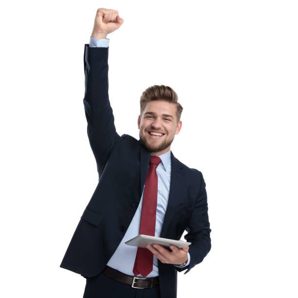 istock Young businessman celebrating and holding his tablet 1162111944