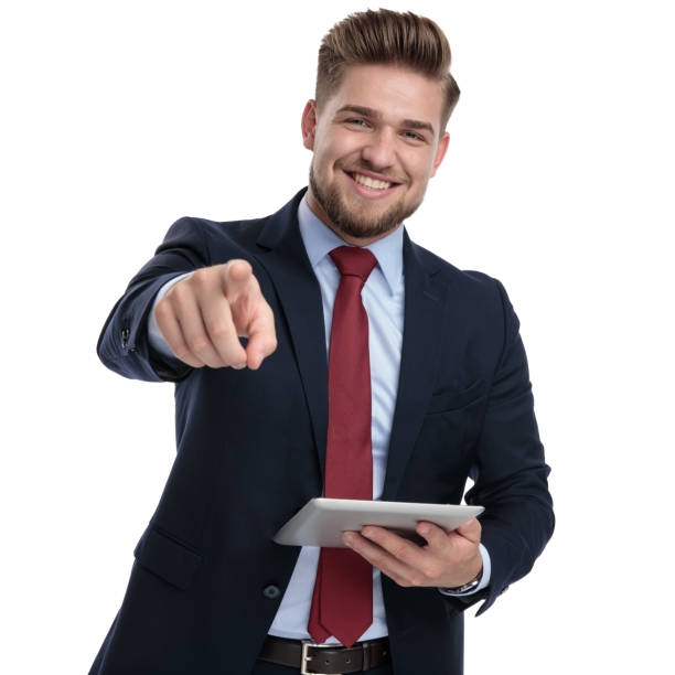 istock Cheerful businessman pointing and holding a tablet 1162112663