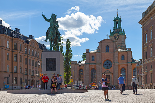 Stockholm, Sweden - June 24 2019: Statue of Charles XIV John on Karl Johans Torg (Swedish: Square of Charles John), a public square between the old town Gamla stan and Slussen. Behind, it is Storkyrkan, officially named Sankt Nikolai kyrka (Church of St. Nicholas).