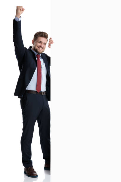 istock Businessman celebrating beside a blank billboard 1162115642