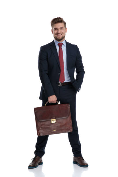 istock Cheerful businessman holding his briefcase and smiling 1162115972