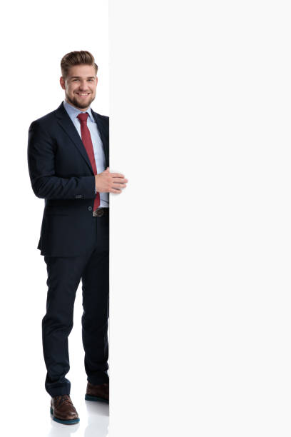 istock Attractive businessman holding a big empty billboard 1162116345