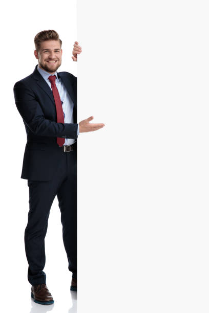 istock Positive businessman presenting an empty billboard and smiling 1162116414