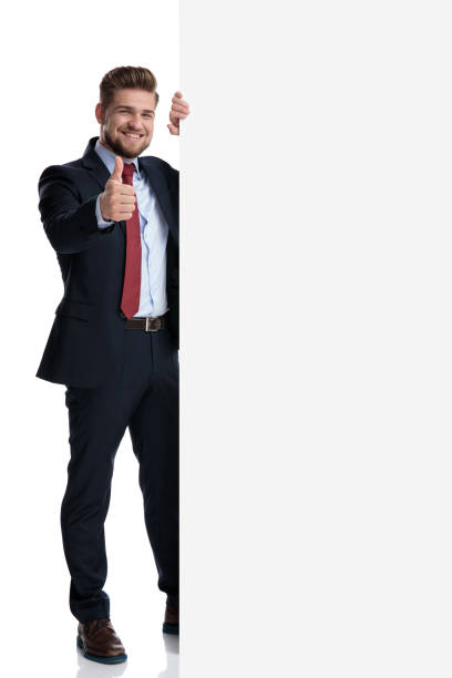 istock Handsome businessman gesturing ok beside a blank billboard 1162117253