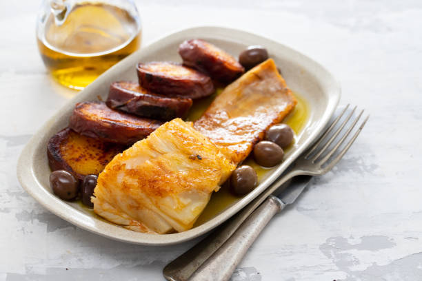 istock fried cod fish with olives and sweet potato on dish 1162117592