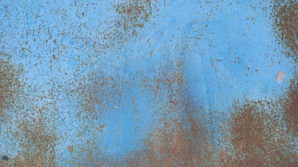 istock Metal wall painted blue and damaged by rust. Background. Close-up. 1162118510