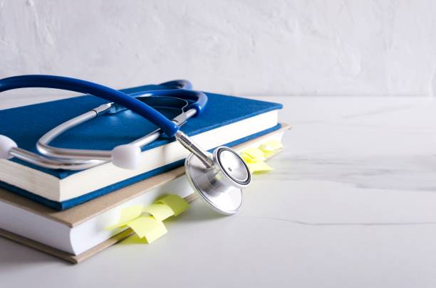 istock Notebook,medical book and stethoscope on the white table.Empty space for text 1162119233