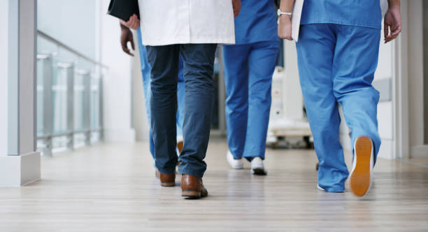 Setting off to save more lives Closeup shot of a group of unrecognisable doctors walking in a hospital unrecognizable person stock pictures, royalty-free photos & images